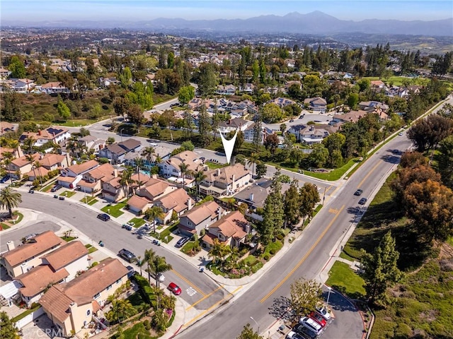 drone / aerial view featuring a residential view and a mountain view