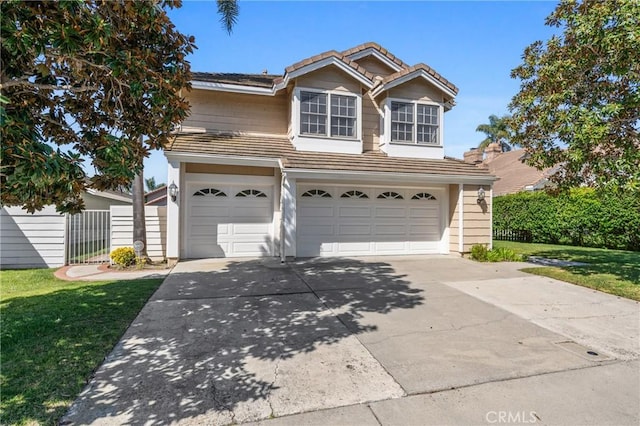 traditional home featuring a front lawn, fence, concrete driveway, an attached garage, and a tile roof