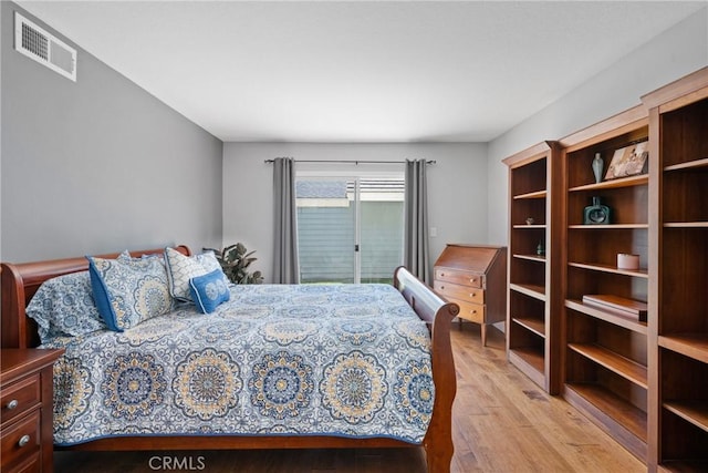 bedroom featuring access to exterior, light wood finished floors, and visible vents