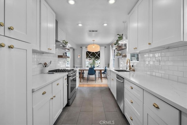 kitchen featuring light countertops, a sink, white cabinets, and stainless steel appliances