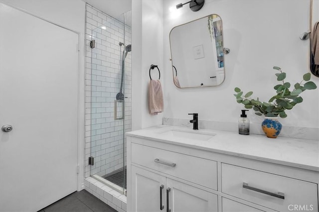 bathroom with vanity, tile patterned flooring, and a stall shower