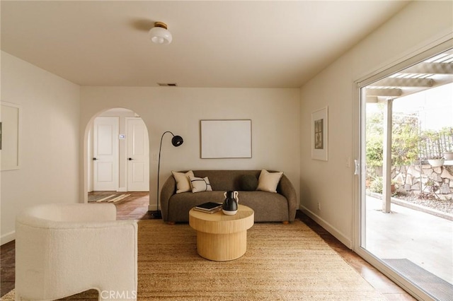 1541 Indiana Ave, South Pasadena, CA 91030 - living room featuring arched walkways, baseboards, visible vents, and wood finished floors