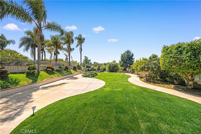 surrounding community featuring a lawn and fence