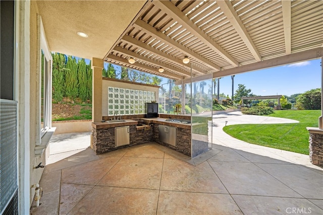 view of patio with an outdoor kitchen, a sink, and a pergola
