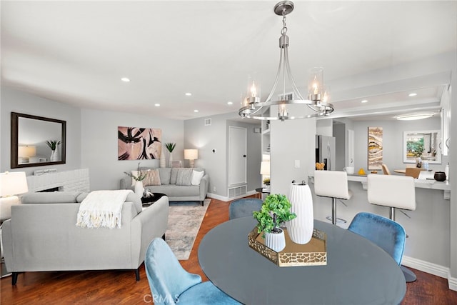 dining area featuring recessed lighting, baseboards, a notable chandelier, and wood finished floors