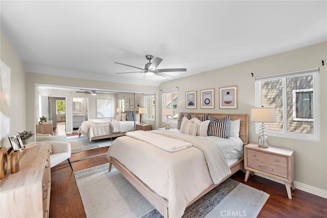 bedroom featuring baseboards, ceiling fan, and dark wood-style floors