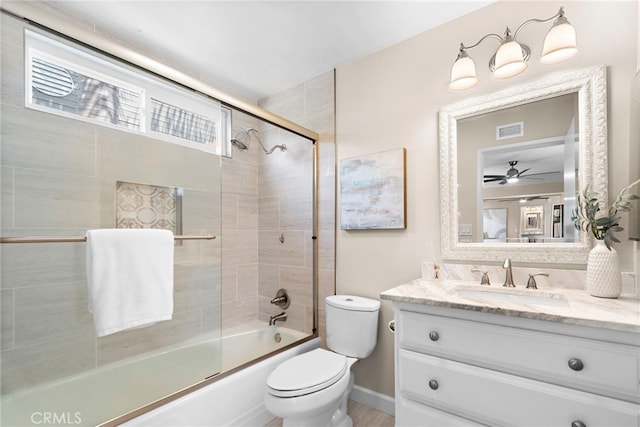 full bathroom with ceiling fan, visible vents, vanity, toilet, and enclosed tub / shower combo