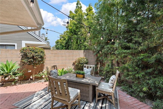 view of patio with fence and outdoor dining space