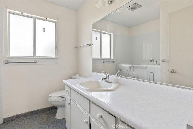 bathroom with tile patterned flooring, visible vents, vanity, toilet, and baseboards