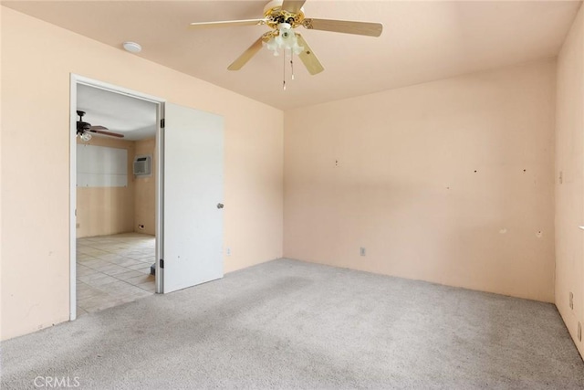 unfurnished bedroom with carpet floors, ceiling fan, and a wall mounted air conditioner