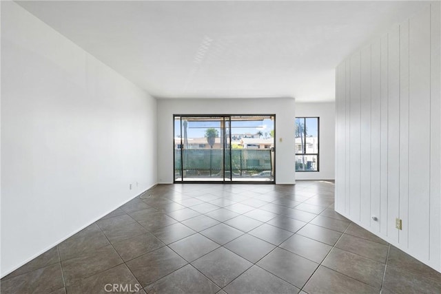 spare room with dark tile patterned flooring