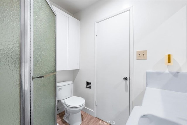 bathroom featuring toilet and wood finished floors