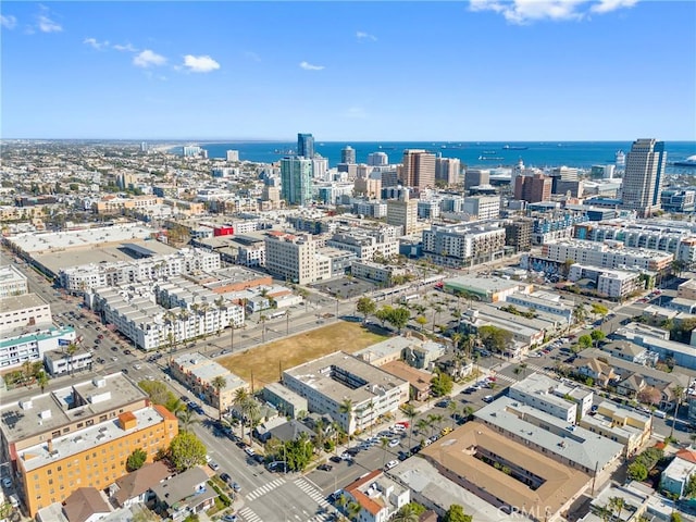 drone / aerial view with a city view and a water view