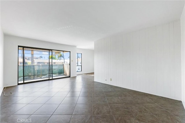 unfurnished room with dark tile patterned floors