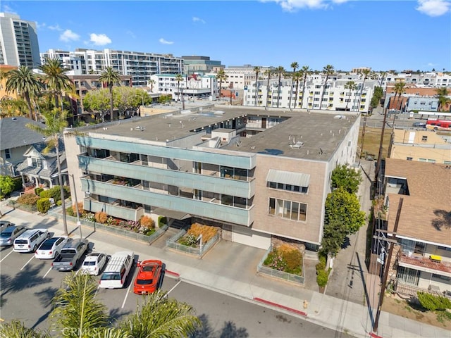 view of building exterior featuring a city view and uncovered parking