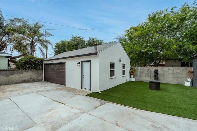 view of outbuilding with fence and driveway