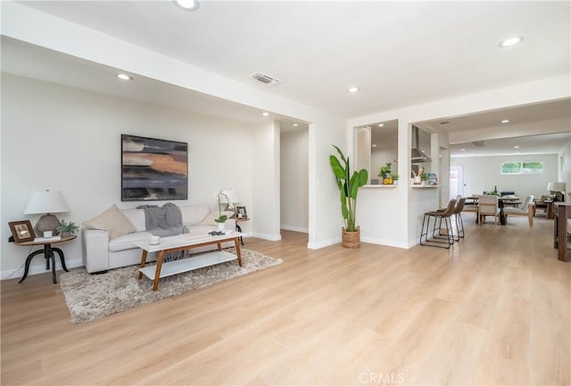 living room featuring visible vents, recessed lighting, light wood-style floors, and baseboards