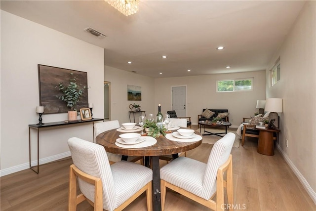 dining room featuring light wood-style floors, baseboards, recessed lighting, and visible vents