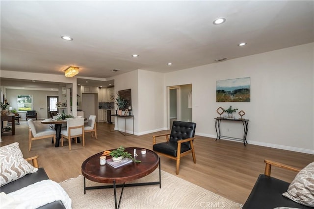 living area with light wood-style floors, recessed lighting, baseboards, and visible vents