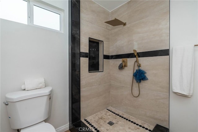 full bath featuring toilet and a tile shower