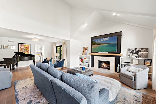 9401 Gateshead Dr, Huntington Beach, CA 92646 - living room featuring visible vents, a high end fireplace, vaulted ceiling, wood finished floors, and baseboards