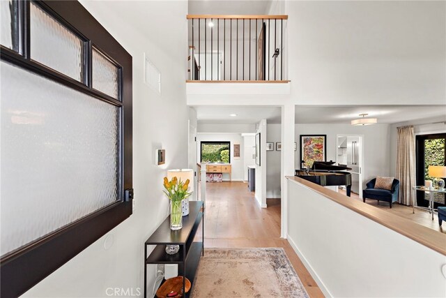 9401 Gateshead Dr, Huntington Beach, CA 92646 - entryway featuring a healthy amount of sunlight, a towering ceiling, wood finished floors, and visible vents