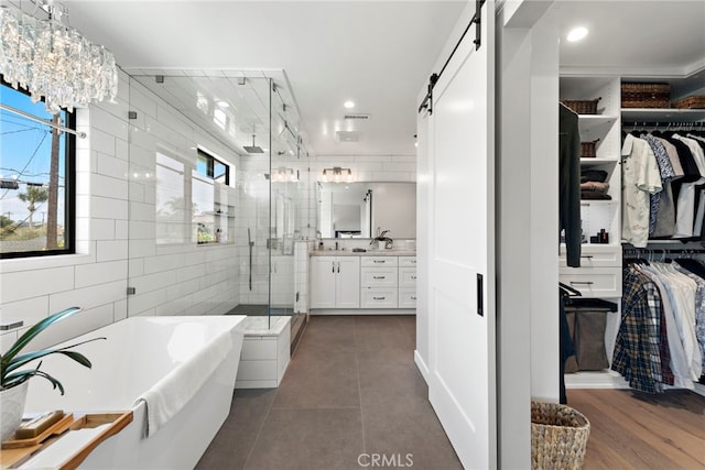 9401 Gateshead Dr, Huntington Beach, CA 92646 - bathroom with a walk in closet, a freestanding bath, tile patterned flooring, a shower stall, and vanity