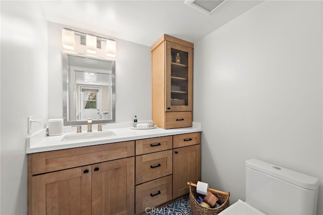 9401 Gateshead Dr, Huntington Beach, CA 92646 - bathroom featuring visible vents, toilet, and vanity