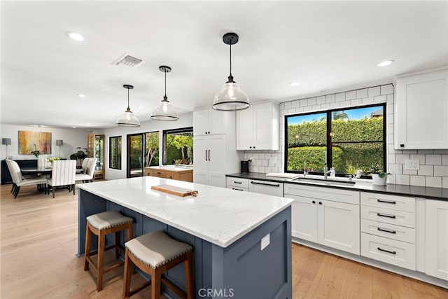 9401 Gateshead Dr, Huntington Beach, CA 92646 - kitchen with a sink, decorative backsplash, dishwasher, and visible vents