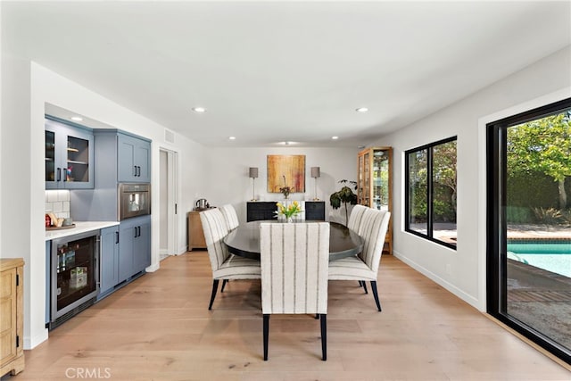 9401 Gateshead Dr, Huntington Beach, CA 92646 - dining space with light wood finished floors, recessed lighting, and beverage cooler