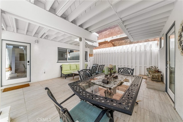 wooden terrace featuring outdoor dining area and fence