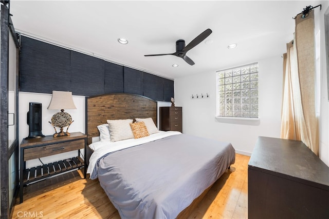 bedroom with recessed lighting, light wood-type flooring, ceiling fan, and baseboards