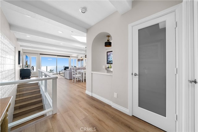 corridor featuring wood finished floors, baseboards, and recessed lighting