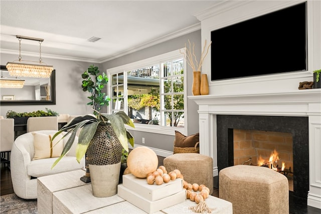 living area with visible vents, ornamental molding, and a fireplace