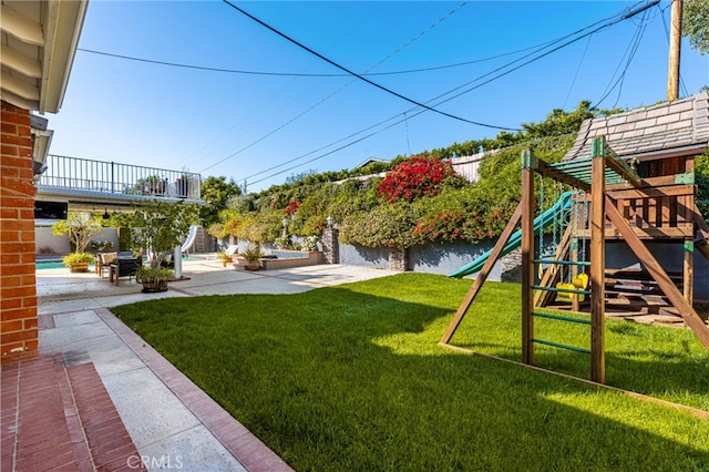 view of yard with a playground, a patio, and a fenced backyard