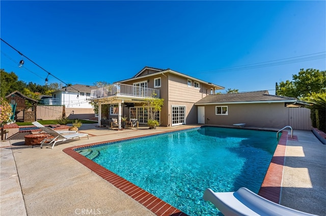 view of pool featuring a diving board, fence, a patio area, and a fenced in pool