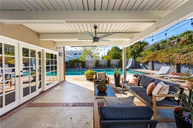 view of patio with a ceiling fan, french doors, a fenced in pool, an outdoor hangout area, and a fenced backyard