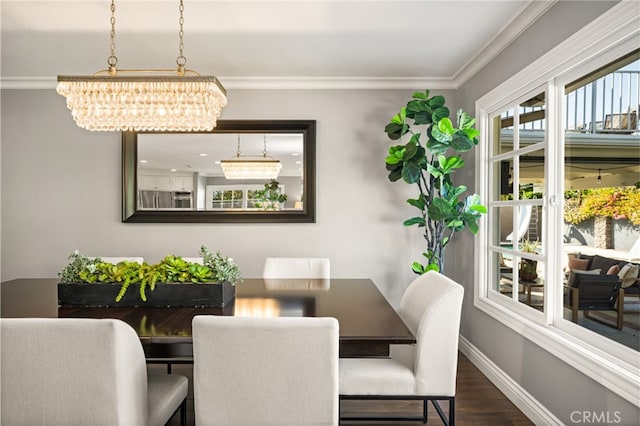 dining area featuring an inviting chandelier, baseboards, ornamental molding, and wood finished floors