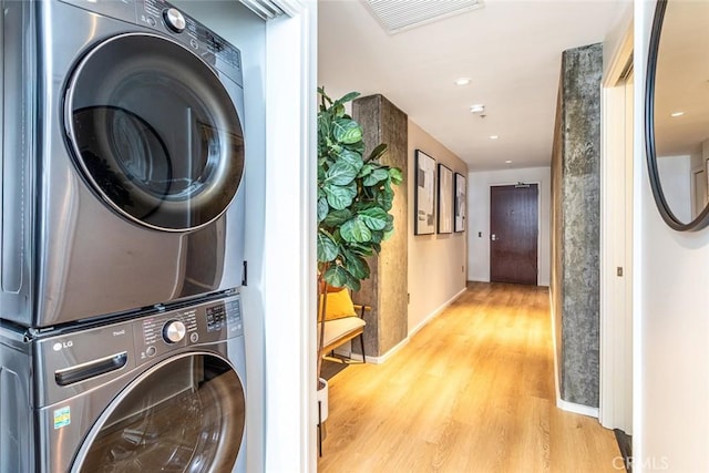 1155 S Grand Ave Unit 1011, Los Angeles, CA 90015 - laundry area featuring stacked washing machine and dryer and wood finished floors