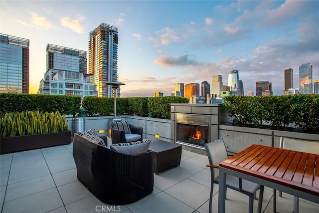 1155 S Grand Ave Unit 1011, Los Angeles, CA 90015 - view of patio with a skyline view and an outdoor living space with a fireplace