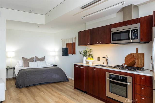1155 S Grand Ave Unit 1011, Los Angeles, CA 90015 - kitchen with stainless steel appliances, light countertops, light wood-style floors, and modern cabinets