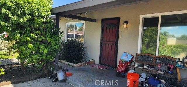 property entrance with stucco siding