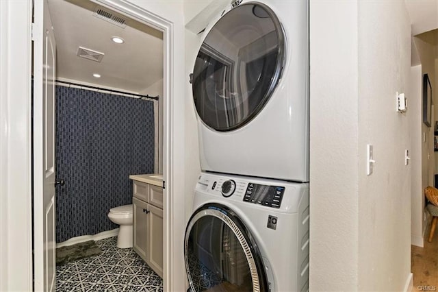 8892 Katella Ave Unit 12, Anaheim, CA 92804 - clothes washing area with stacked washer and clothes dryer and recessed lighting