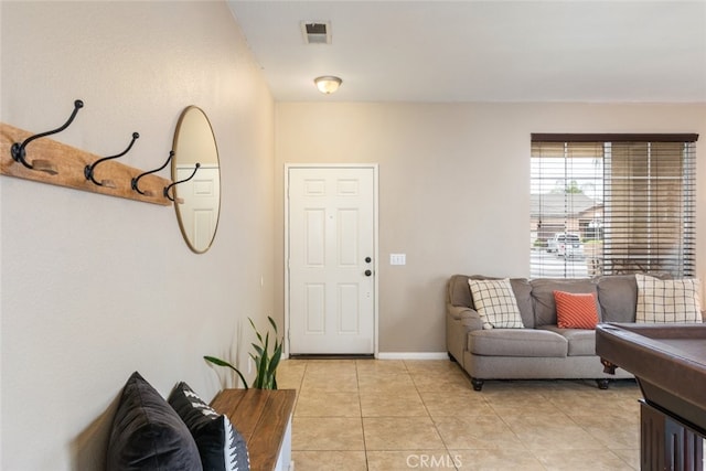 foyer entrance with visible vents, baseboards, and light tile patterned floors