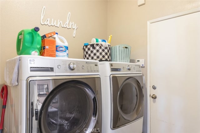 laundry room featuring separate washer and dryer and laundry area