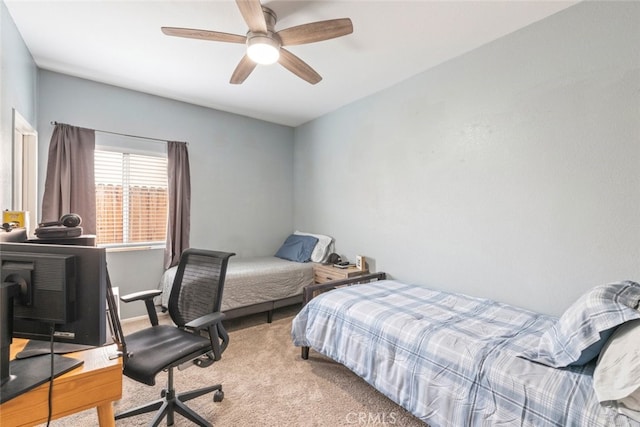 bedroom with a ceiling fan and carpet flooring