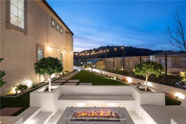 view of property's community with an outdoor fire pit