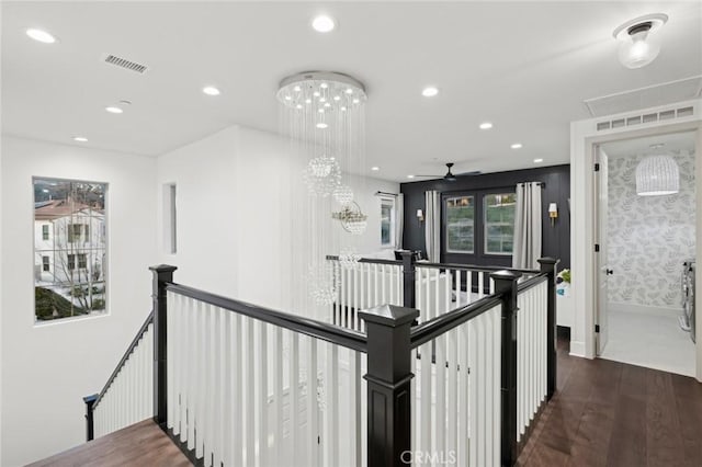 hallway featuring recessed lighting, an upstairs landing, dark wood-style floors, and visible vents
