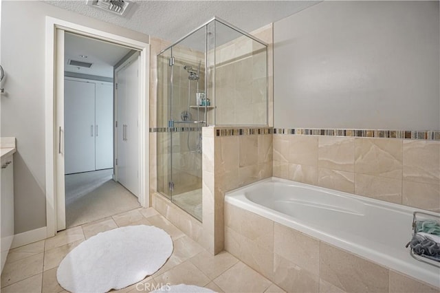 bathroom featuring visible vents, tile patterned flooring, a textured ceiling, a bath, and a shower stall