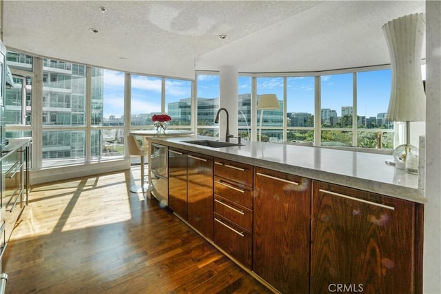 3141 Michelson Dr Unit 508, Irvine, CA 92612 - kitchen featuring a sink, a view of skyline, a textured ceiling, dark wood-type flooring, and plenty of natural light